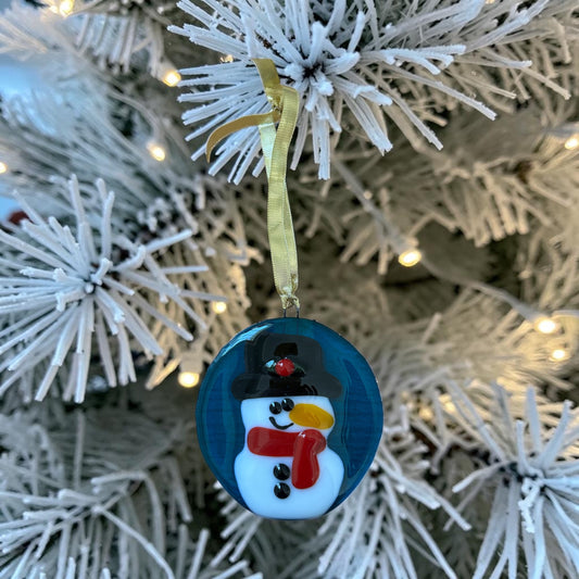 Homemade Fused Glass Snowman Ornament on Blue Background